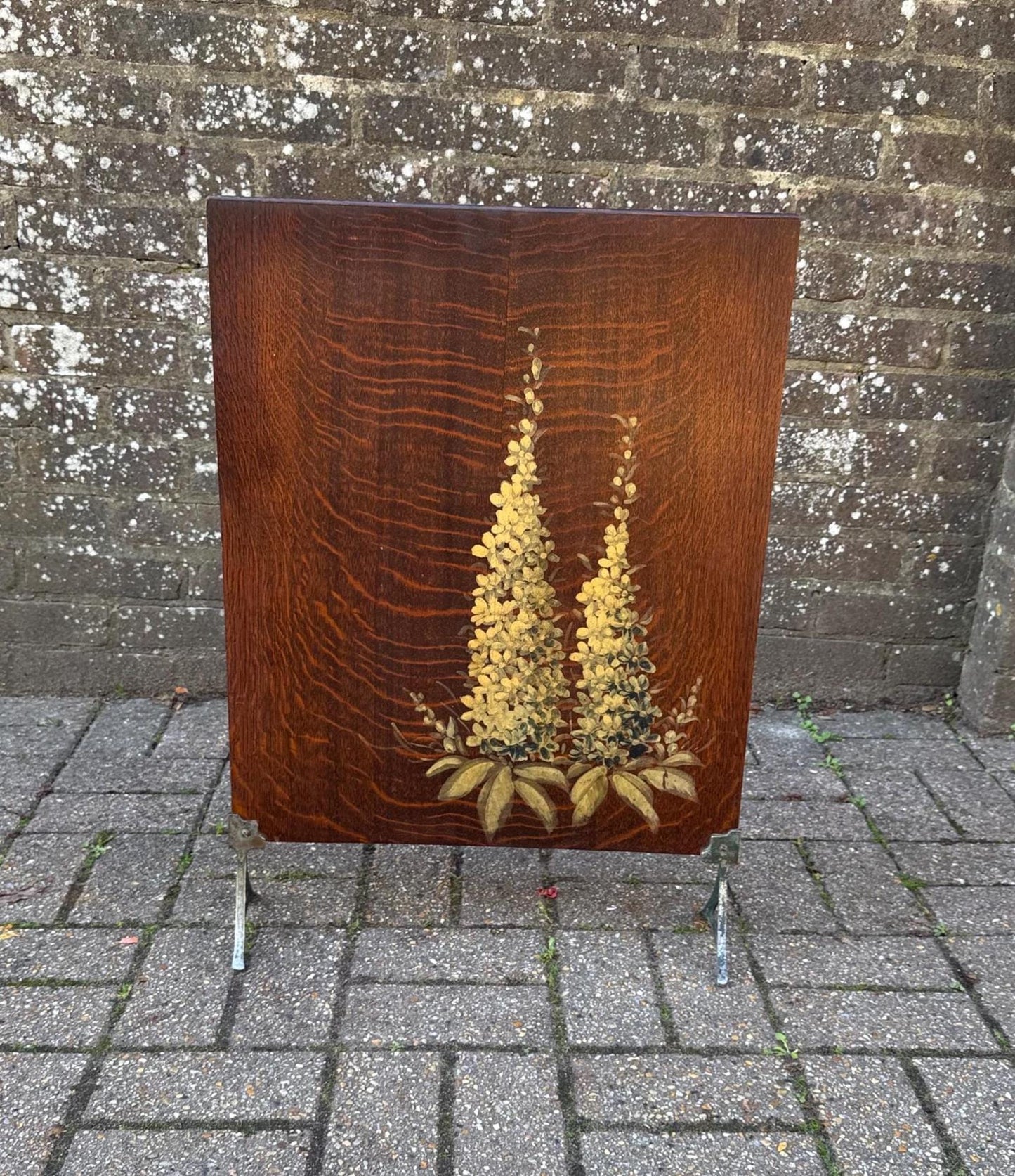 1930s fire screen amde out of wood with hand painted decoration. delightful wooden screen on chrome legs